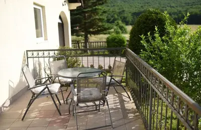 a table and chairs sitting on a balcony at Perisa in Livno