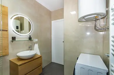 a bathroom with a sink and a mirror at Apartman Krželj B3 in Livno
