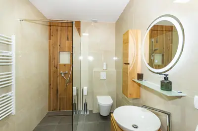 a bathroom with a shower and a toilet and a sink at Apartman Krželj B3 in Livno