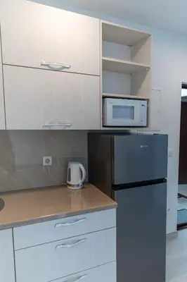 a kitchen with a refrigerator and a microwave at Apartman Krželj B3 in Livno