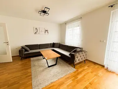 a living room with a couch and a table at Apartman Sučić in Livno