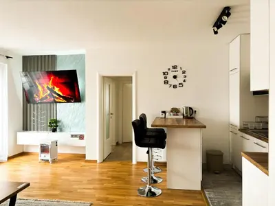 a kitchen with a bar stool in the middle of a room at Apartman Sučić in Livno