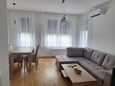 a living room with a couch and a table at Apartman Una banjaluka in Hiseti