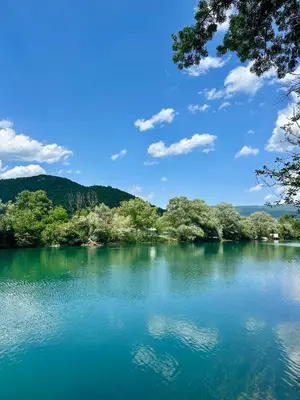 a view of a lake with trees on the shore at Unavis Residence in Bihać