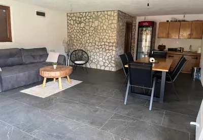a living room with a couch and a table at Vikendica Krupa na Vrbasu in Banja Luka