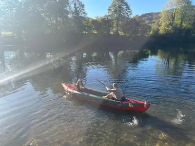 a man in a red boat on a river at Vikendica Krupa na Vrbasu in Banja Luka