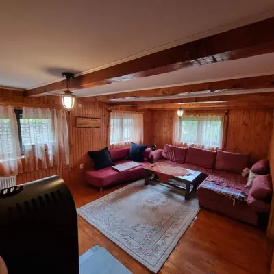 a living room with a couch and a table at A&S vikendica Vlašić in Šišava