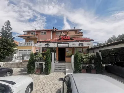 a house with a car parked in front of it at Apartman Marija in Livno