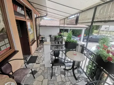 a balcony of a restaurant with tables and chairs at Apartman Marija in Livno