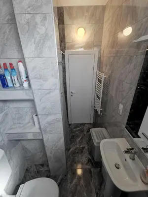a bathroom with a white toilet and a sink at Apartman Marija in Livno