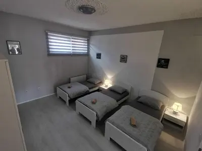a bedroom with two beds and a window with a window at Apartman Marija in Livno