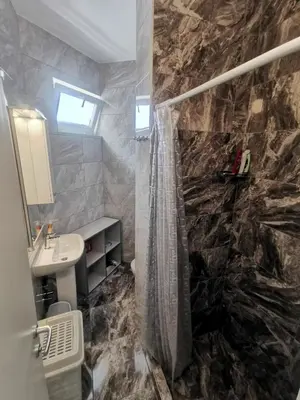 a bathroom with a shower curtain and a sink at Apartman Marija in Livno