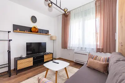a living room with a couch and a tv at Apartman Krželj B1 in Livno