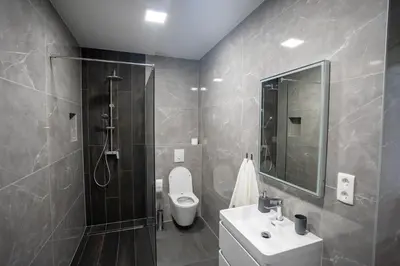 a bathroom with a toilet and a sink and a shower at Apartman Krželj B1 in Livno