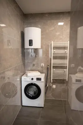 a washing machine in a bathroom with a toilet at Apartman Krželj B1 in Livno