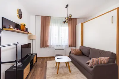 a living room with a couch and a table at Apartman Krželj B1 in Livno