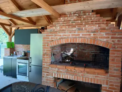 a brick fireplace in the middle of a kitchen at Pure Nature in Bihać
