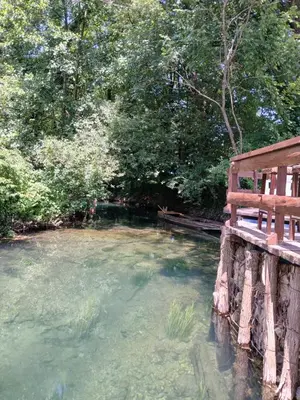 a large pool of water with a bench in it at Pure Nature in Bihać