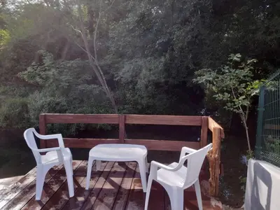 two white chairs and a table and a bench at Pure Nature in Bihać