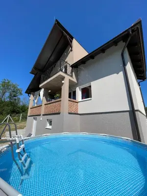 a villa with a swimming pool in front of a house at Vikendica Villa Ramona Banja Luka in Banja Luka
