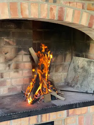 a brick oven with a fire in it at Vikendica Villa Ramona Banja Luka in Banja Luka