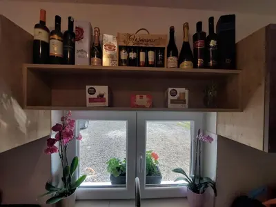 a window with a bunch of bottles of wine at Vikendica Villa Ramona Banja Luka in Banja Luka