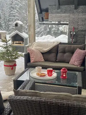 a patio with a couch and a table with a plate of food at Farmhouse Dženi in Vlasic