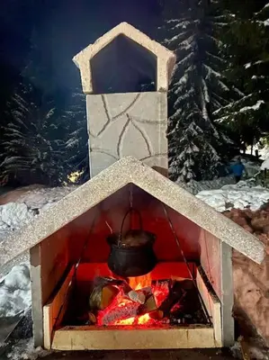 a pot over a fire in a stone oven at Farmhouse Dženi in Vlasic