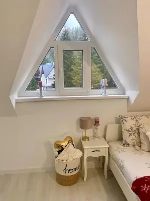 a room with a window and a couch and a table at Farmhouse Dženi in Vlasic