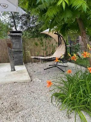 a tent in a garden with flowers and a fence at Una in Bihać