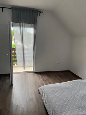 a bedroom with a bed and a sliding glass door at Una in Bihać
