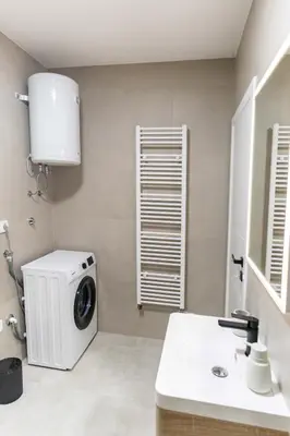 a laundry room with a washing machine and a sink at Apartman Krželj B4 in Livno
