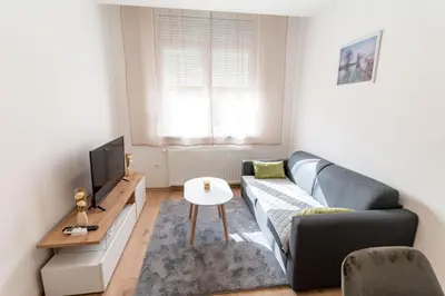 a living room with a couch and a tv at Apartman Krželj B4 in Livno
