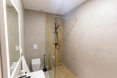 a bathroom with a shower with a toilet and a sink at Apartman Krželj B4 in Livno