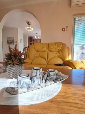 a living room with a couch and a tray of rocks at Apartman Ajla in Bihać