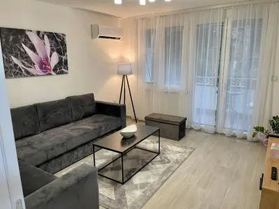 a living room with a couch and a table at ANET Apartman Visoko in Visoko