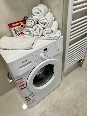 a washing machine with towels on top of it at ANET Apartman Visoko in Visoko