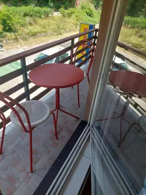 a red table and chairs on a balcony at 33 Lipe in Travnik