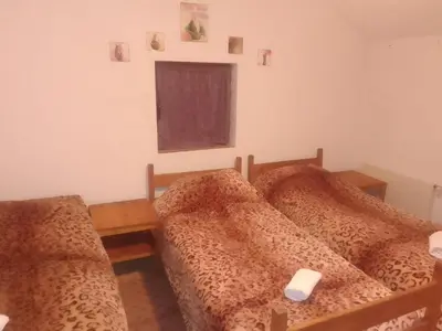two beds in a room with a window at 33 Lipe in Travnik