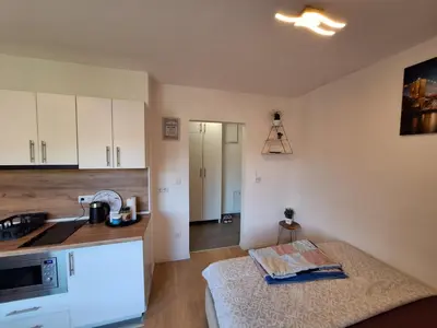 a kitchen with a sink and a microwave at Apartmani Sarah 3 Tuzla in Tuzla