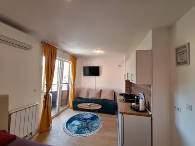 a living room with a couch and a table at Apartmani Sarah 3 Tuzla in Tuzla
