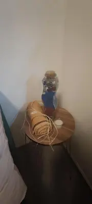 a small table with a vase on top of it at Apartmani Sarah 4 Tuzla in Tuzla