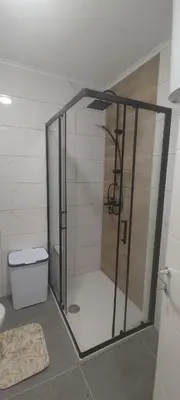 a shower with a glass door in a bathroom at Apartmani Sarah 4 Tuzla in Tuzla