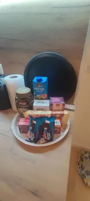 a plate with books and other food on a table at Apartmani Sarah 4 Tuzla in Tuzla