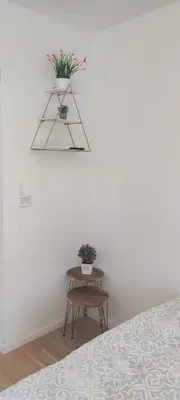 a room with a bed and a table with plants at Apartmani Sarah 4 Tuzla in Tuzla