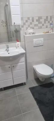 a white bathroom with a toilet and a sink at Ivan in Livno
