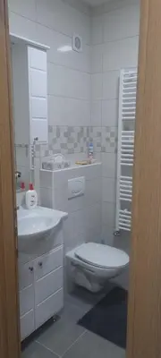 a white bathroom with a toilet and a sink at Ivan in Livno