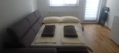 a couch with two pillows on it in a living room at Ivan in Livno