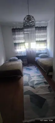 a bedroom with two beds and a window at Apartman Dijana in Livno