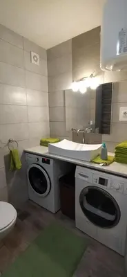 a bathroom with two washing machines and a sink at Apartman Dijana in Livno